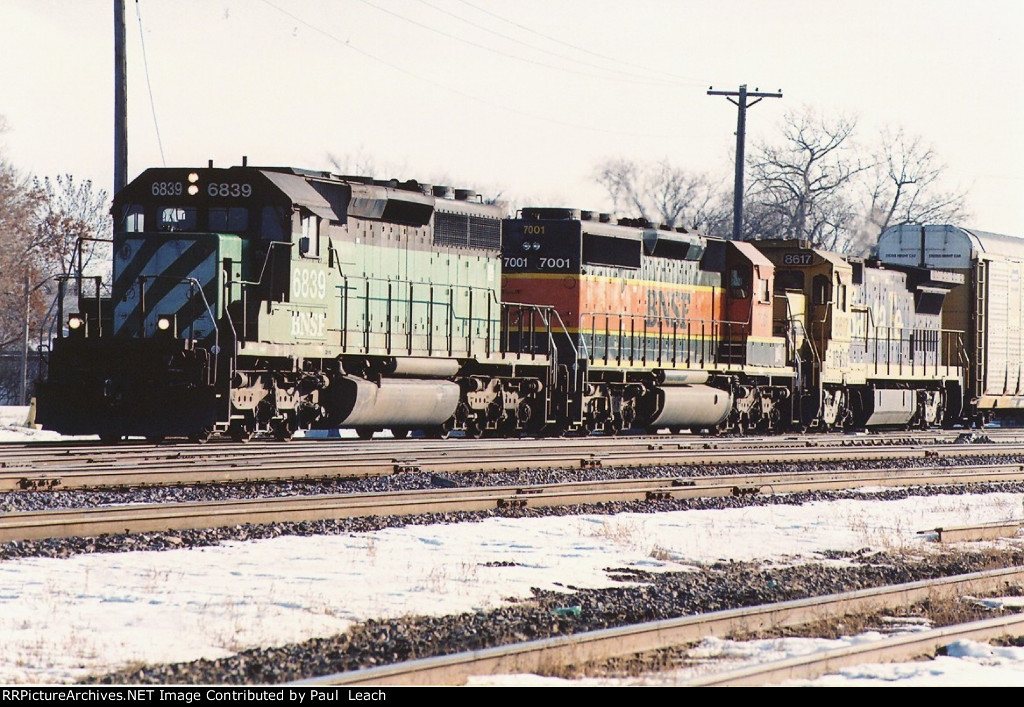 Vehicle train rolls west through University